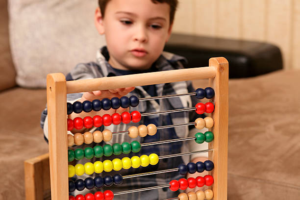 https://www.splashlearn.com/blog/wp-content/uploads/2022/05/Child-playing-with-abacus-Toys-for-Autistic-Kids.jpg