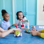 Woman sitting with children talkin and playing