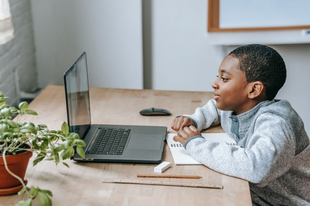 Boy watching a video on laptop