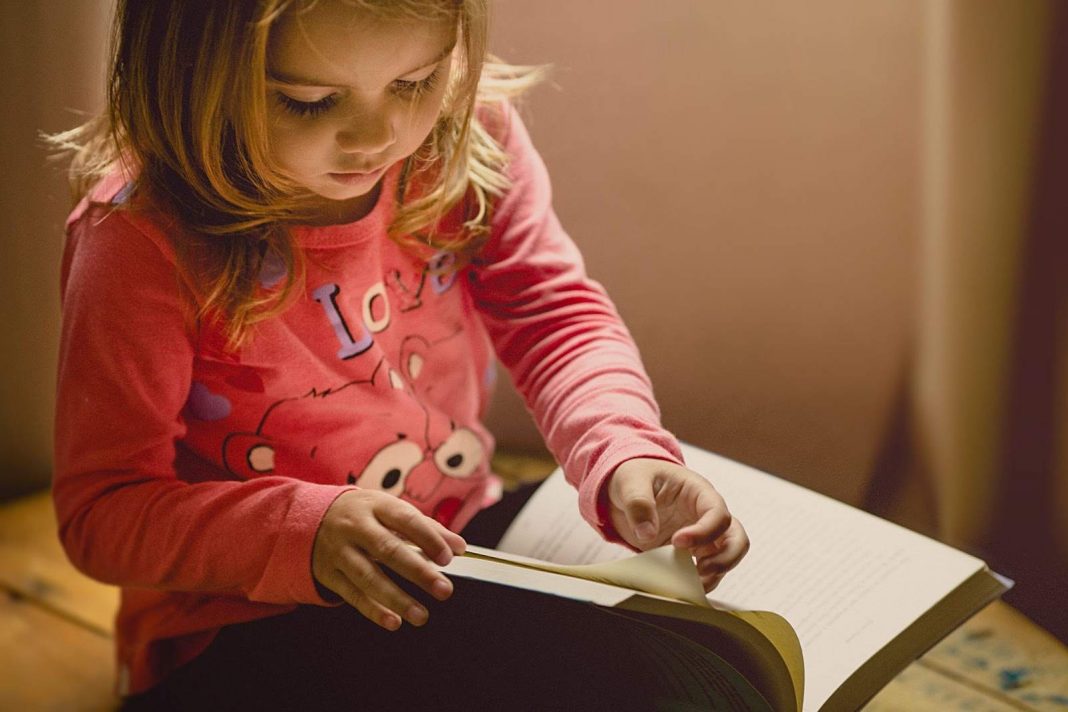 Girl reading a book sincerely