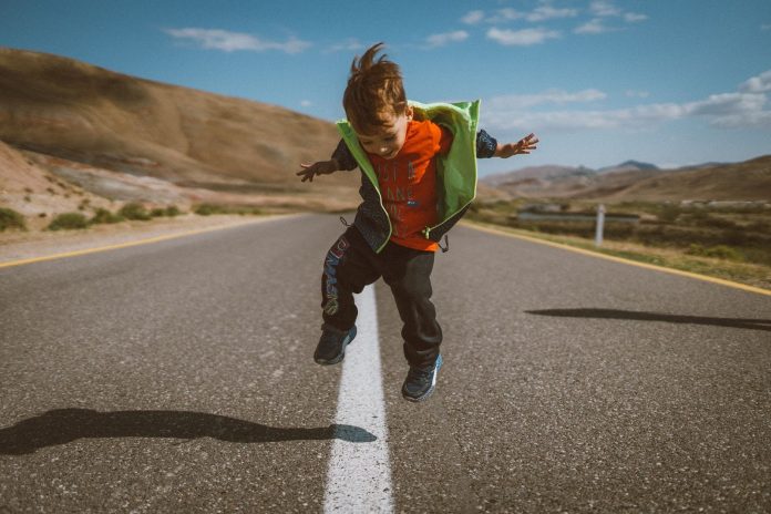 Kid jumping on the road