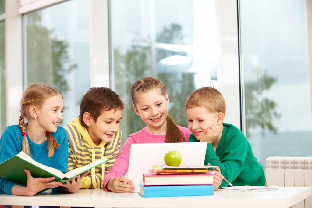 Group of kids using a laptop