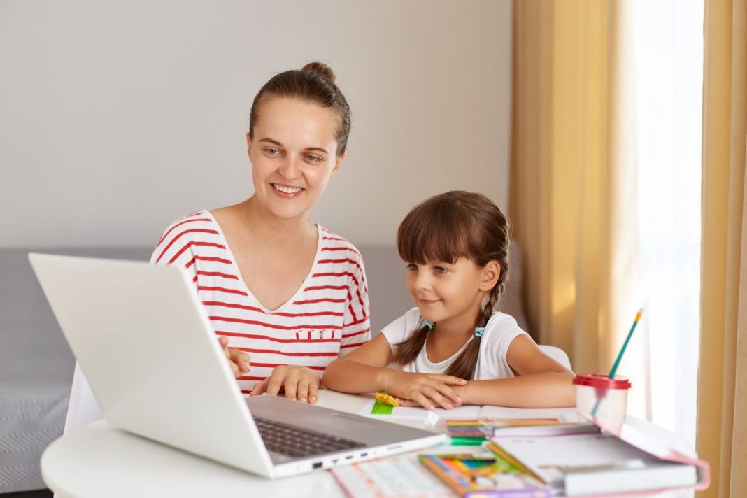 Mother homeschooling her daughter