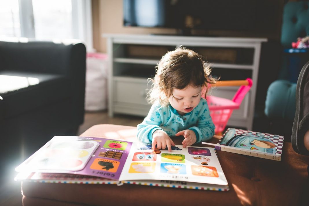 Little kid reading a picture book