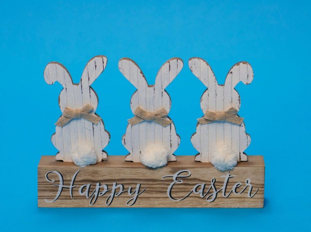 3 wooden bunny figures on a wooden cuboid