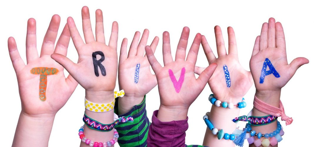 Kids hands with trivia written on them