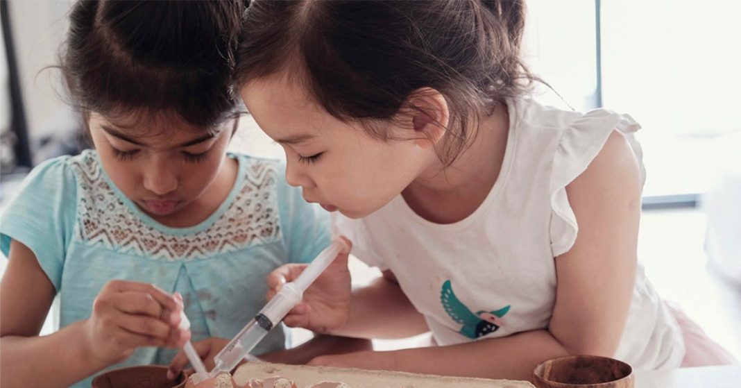 Two girls performing a science experiment