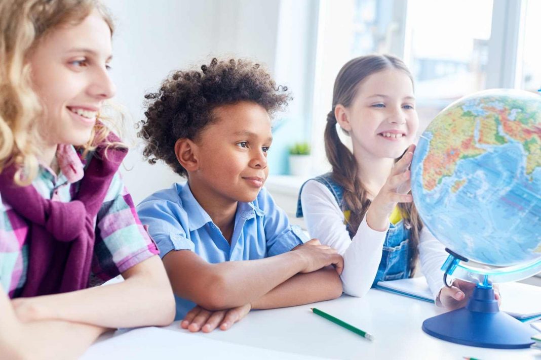 Kids looking at a globe