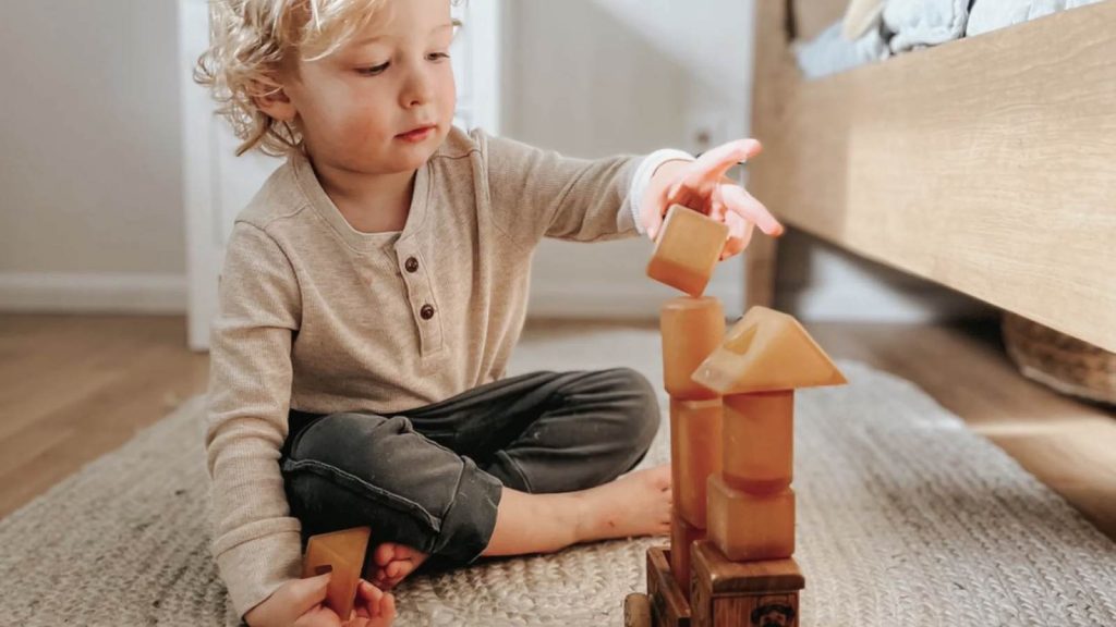 kid playing with building blocks