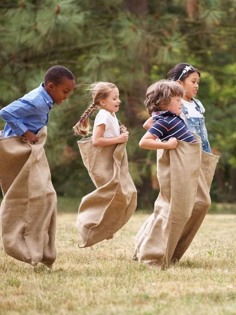 An image of kids playing jump in the sack