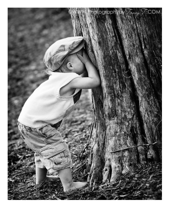 An image of a boy playing hide and seek