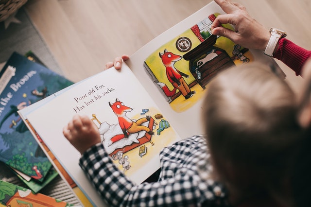 Image of a kid reading a storybook