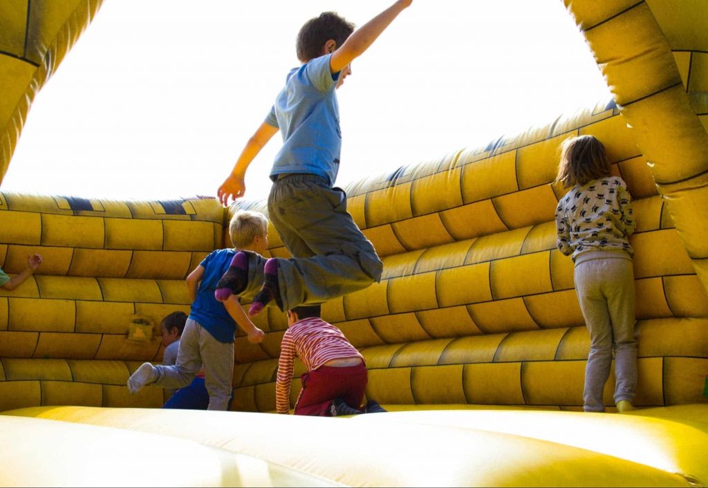 An image of kids jumping & playing
