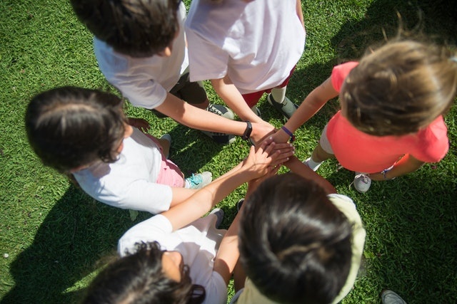 Kids participating in outdoor team building activities