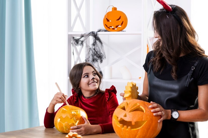 A girl and her mom painting pumpkin together