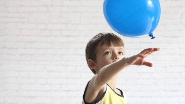 Four year old Kid playing with a balloon