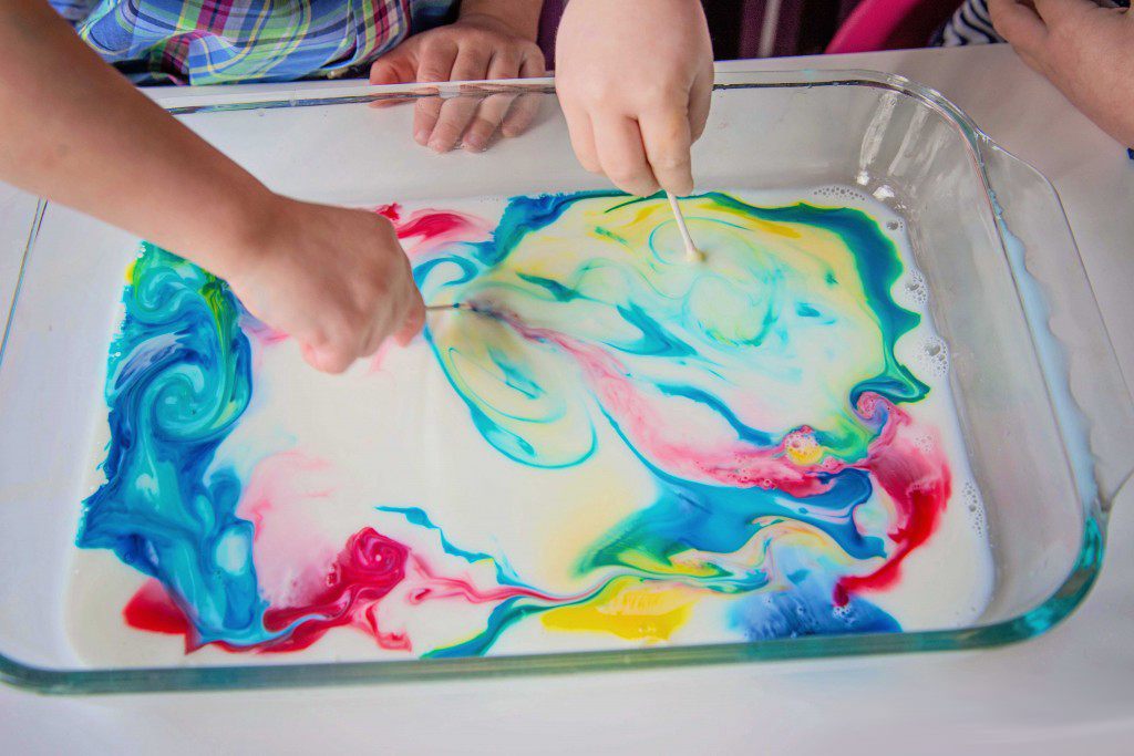 Kid swirling color in milk