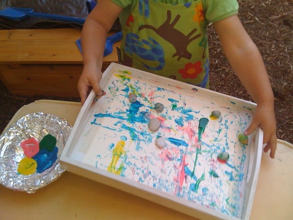 Kid using marble to create painting