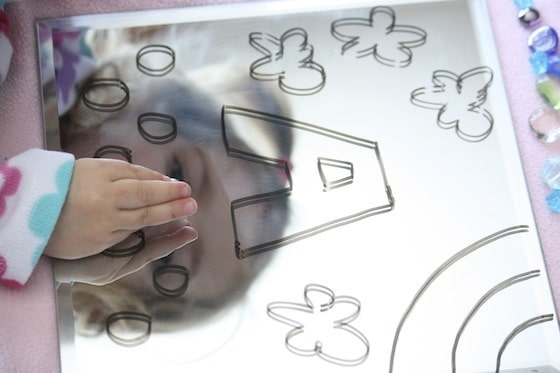 Kid drawing on mirror