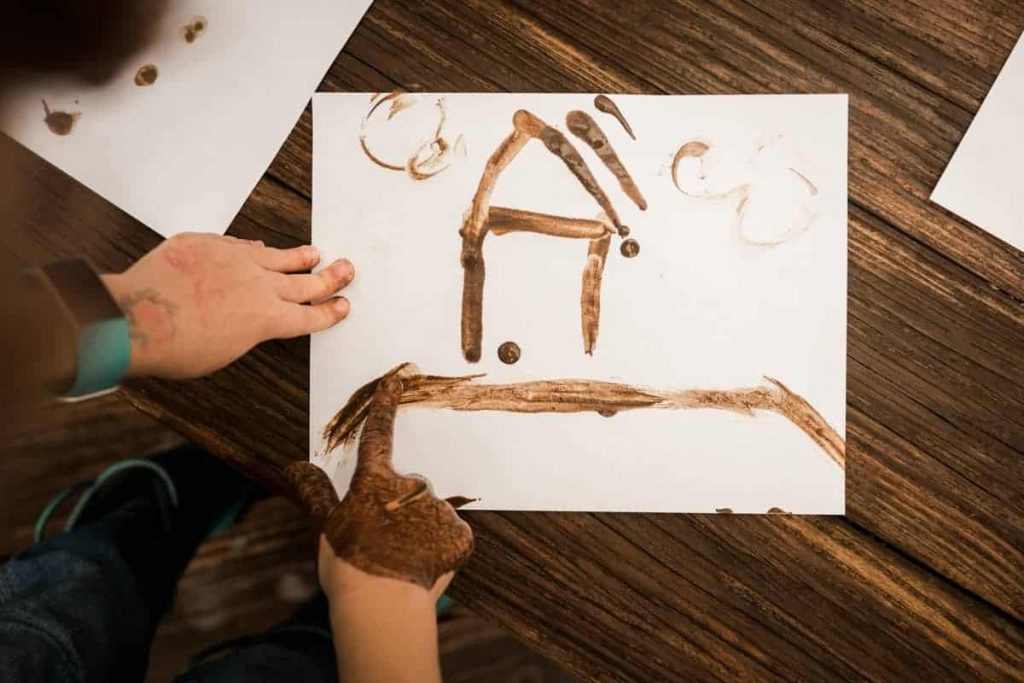 Kid painting with mud