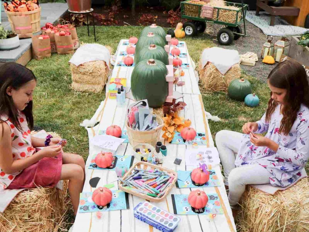 Kids decorating pumpkin