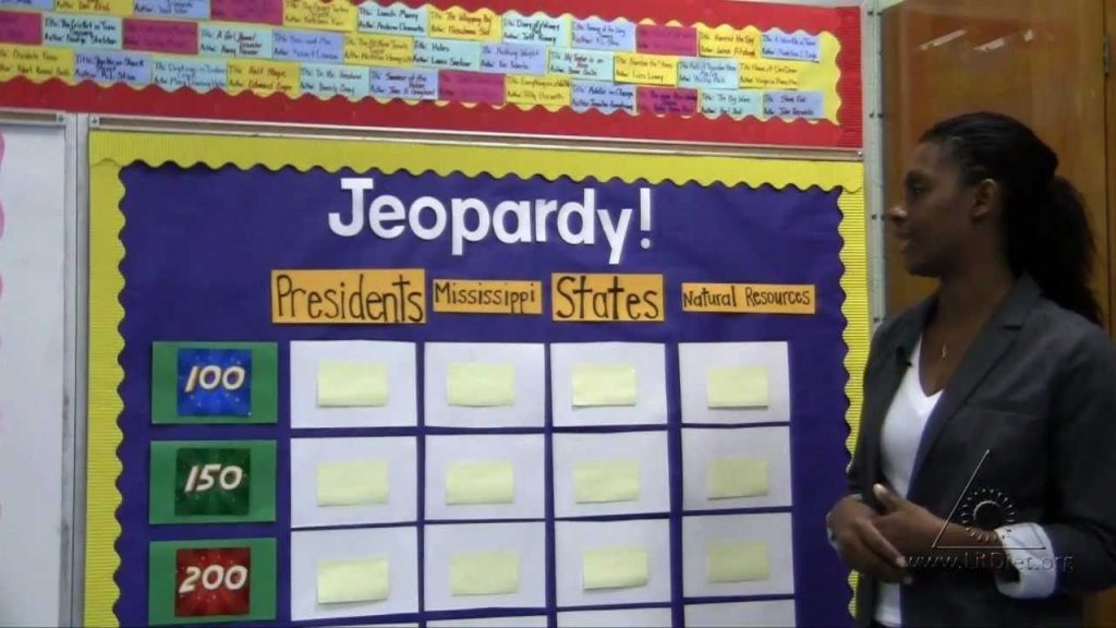 Teacher using Jeopardy game to engage students to review a unit of study